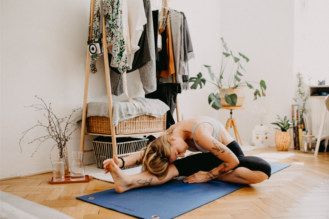 woman streching, doing yoga in yoga mat