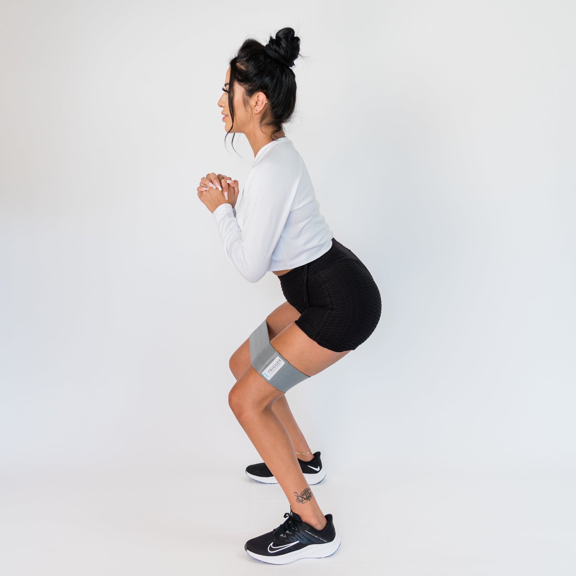 Woman squatting with the Dynamic Loop Bands